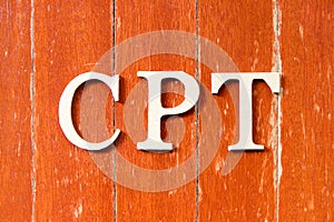 Alphabet in word  CPT Abbreviation of Carriage Paid To on old red color wood plate background