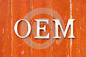 Alphabet in word OEM Abbbreviation of Original Equipment Manufacturer on old red color wood plate background