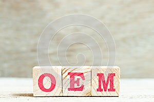 Alphabet in word OEM Abbreviation of Original Equipment Manufacturer on wood background