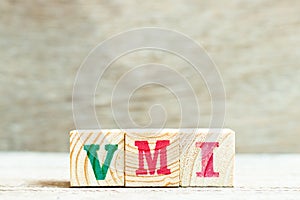 Alphabet in word VMI abbreviation of vendor managed inventory on wood background