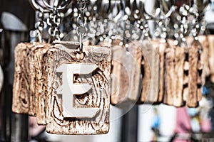 Alphabetical keychains close-up. Close up of letter E in front.