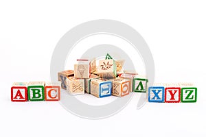 Alphabets cubes scattered on white background with a selective focused on ABC and XYZ alphabets photo