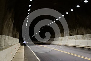 Alphalt road in a dark tunnel in Mendoza, Argentina