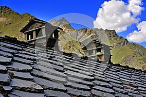 Alpien roof with chimneys in mountains