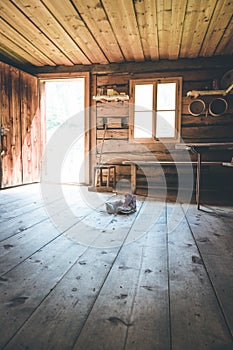 Alpine boots on rustic wood floor in an abandoned mountain chalet in Austria