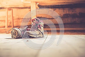 Alpine boots on rustic wood floor in an abandoned mountain chalet in Austria