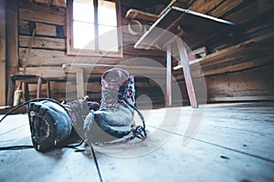 Alpine boots on rustic wood floor in an abandoned mountain chalet in Austria