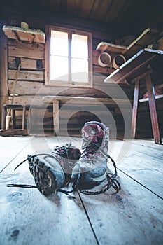 Alpine boots on rustic wood floor in an abandoned mountain chalet in Austria