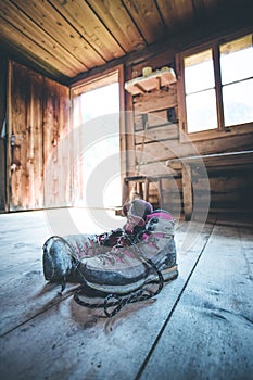 Alpine boots on rustic wood floor in an abandoned mountain chalet in Austria