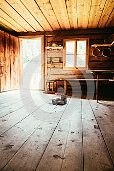 Alpine boots on rustic wood floor in an abandoned mountain chalet in Austria