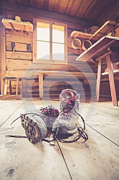 Alpine boots on rustic wood floor in an abandoned mountain chalet in Austria