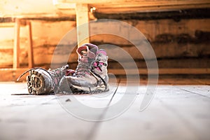 Alpine boots on rustic wood floor in an abandoned mountain chalet in Austria photo