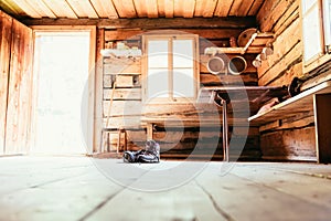Alpine boots on rustic wood floor in an abandoned mountain chalet in Austria photo
