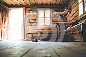 Alpine boots on rustic wood floor in an abandoned mountain chalet in Austria photo