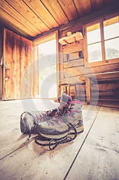 Alpine boots on rustic wood floor in an abandoned mountain chalet in Austria photo