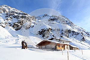 Alpine chalet house and mountain panorama with snow in winter in Stubai Alps