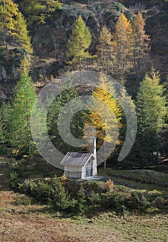 Alpine Chapel against Fall trees