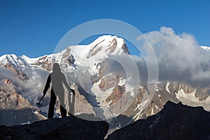 Alpine Climber Arranging Descent with Rope and Ice Axe