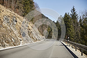 Alpine country road in the Austrian Alps - Stock Photo