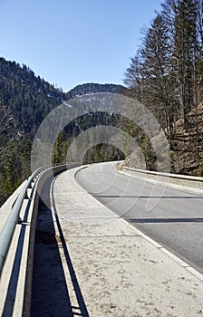 Alpine country road in the Austrian Alps - Stock Photo