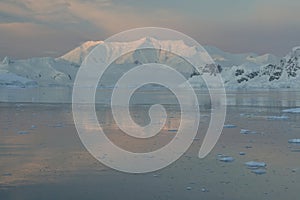 Alpine glow on the beautiful mountains covered in snow in Antarctica