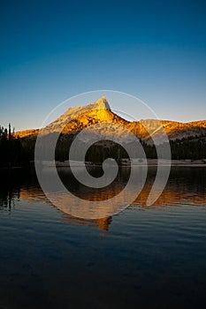 Alpine Glow on Cathedral Peak reflected in the lake photo