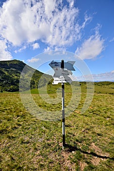 Alpine hiking sign in Rodnei mountains, Romania.