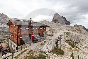 Alpine Hut Bullelejochhutte and mountain Zwolferkofel in Sexten Dolomites, South Tyrol photo