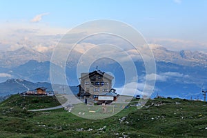 Alpine hut Rifugio Graffer and mountain alps panorama of Adamello-Presanella Alps seen from Brenta Dolomites, Italy