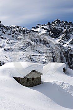 Alpine hut under snow