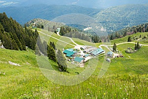 Alpine huts Stiealm at Brauneck mountain, green slope