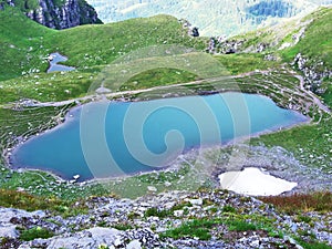 Alpine Lake Baschalvasee under the Pizol peak in the mountain range Glarus Alps