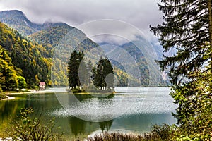 Alpine lake Di Predil in the fog