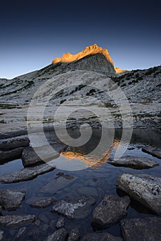 Alpine lake and Noth Peak of Mount Conness at sunrise