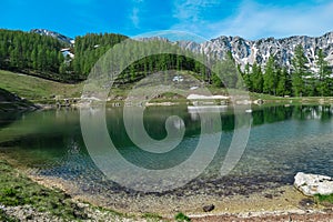 Petzen - Alpine lake with panoramic view of mountain peaks Feistritzer Spitze (Hochpetzen) and Kriznik, Karawanks, Carinthia photo