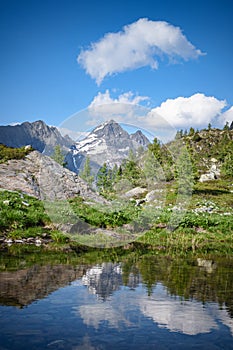 Alpine landscape of the Brembana Valley with small lake and Pizzo del Diavolo