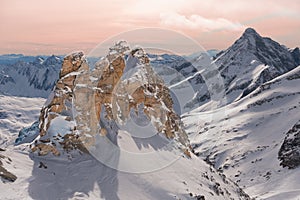 Alpine landscape with peaks covered by snow and clouds, beautiful colors at the top of a glacier