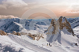 Alpine landscape with peaks covered by snow and clouds, beautiful colors at the top of a glacier