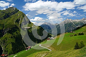 Alpine landscape with scattered houses on a hillside photo