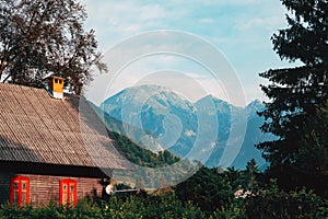 Alpine landscape scenery with distinctive wooden architectural style of mountain houses in slovenian national park Triglav