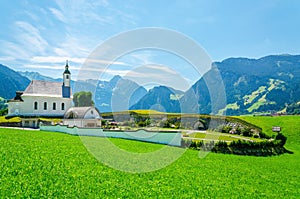 Alpine landscape with typical church Austrian Alps