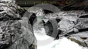 Alpine landscape with wooden bridge over the canyon