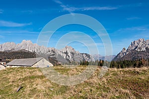Sauris - Alpine mountain cottage Casera Razzo with scenic view of majestic mountains of Carnic Alps photo