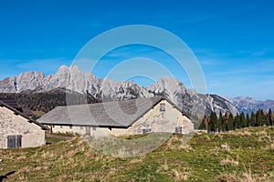 Sauris - Alpine mountain cottage Casera Razzo with scenic view of majestic mountains of Carnic Alps photo