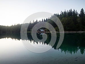Alpine mountain lake boathouse panorama at Laghi di Fusine Weissenfelser See in Tarvisio Udine Dolomites alps Italy