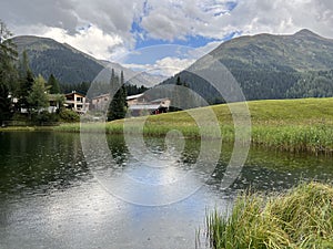 Alpine mountain lake Schwarzsee or Black Lake between the tourist towns of Davos and Klosters - Canton of Grisons, Switzerland