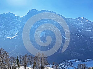 The alpine mountain range GlÃ¤rnisch in the Swiss massif of Glarus alps and over the KlÃ¶ntalersee reservoir lake