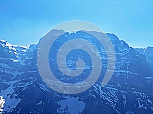 The alpine mountain range GlÃ¤rnisch in the Swiss massif of Glarus alps and over the KlÃ¶ntalersee reservoir lake