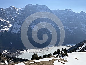 The alpine mountain range GlÃ¤rnisch in the Swiss massif of Glarus alps and over the KlÃ¶ntalersee reservoir lake