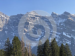 The alpine mountain range GlÃ¤rnisch in the Swiss massif of Glarus alps and over the KlÃ¶ntalersee reservoir lake